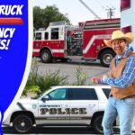 Left-side cartoon graphic reading 'Touch a Truck Emergency Vehicles' with a cowboy character; right side shows a fire truck, a police SUV, and a man in a cowboy hat nearby.