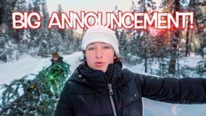 Person in a black puffer jacket and white knit hat in a snowy forest with bold red 'BIG ANNOUNCEMENT!' text overlay (video thumbnail)