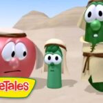 Three VeggieTales characters in desert robes stand with worried expressions, sandy dunes and pyramids in the background.