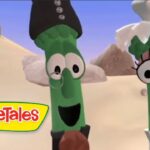 Two green beans with expressive faces wearing clothes stand in a sandy desert, VeggieTales logo visible in the corner.