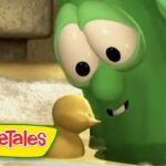 Green VeggieTales cucumber character leaning toward a small yellow duckling, with the VeggieTales logo visible in the corner.