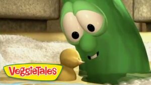 Green VeggieTales cucumber character leaning toward a small yellow duckling, with the VeggieTales logo visible in the corner.