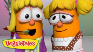 Two carrot-shaped VeggieTales characters with blonde hair smile at each other, one wearing a headset, logo visible at the bottom left.