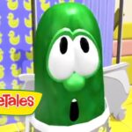 Green cartoon cucumber with big eyes and open mouth in a bright, colorful set; VeggieTales logo visible.