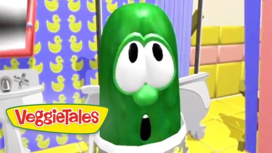 Green cartoon cucumber with big eyes and open mouth in a bright, colorful set; VeggieTales logo visible.