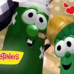 Two green VeggieTales vegetables share a hug with big googly eyes, pink cheeks, and a warm heart motif in the corner.