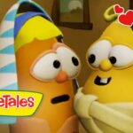 Two VeggieTales characters share a hug, smiling as red hearts surround them, logo at bottom left.