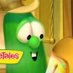Larry the Cucumber from VeggieTales, with a cheerful smile and the VeggieTales logo visible in the corner.