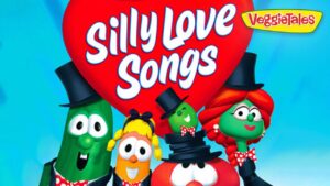 Colorful VeggieTales characters in tuxedos gathered around a large red heart with the words “Silly Love Songs” and a VeggieTales logo in the corner, bright blue background.
