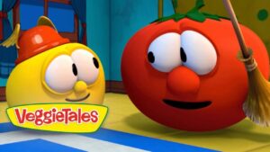 Animated VeggieTales scene: a yellow round character wearing a small red firefighter helmet chats with a red tomato character holding a broom indoors, VeggieTales logo visible.