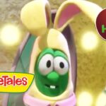 VeggieTales character with a green face wearing a yellow hat and pink collar on a stage, logo in corner, 1.5 HOURS badge visible