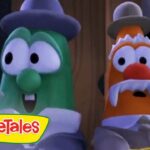 Two VeggieTales characters—a green cucumber and an orange carrot with a mustache—stand side by side, holding a letter with a red seal, looking surprised.