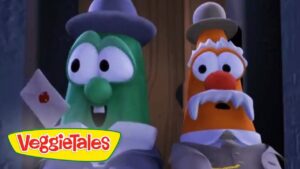 Two VeggieTales characters—a green cucumber and an orange carrot with a mustache—stand side by side, holding a letter with a red seal, looking surprised.