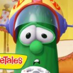 Close-up of a green VeggieTales character wearing a yellow helmet with a surprised expression; VeggieTales logo in the corner.
