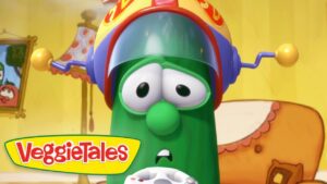 Close-up of a green VeggieTales character wearing a yellow helmet with a surprised expression; VeggieTales logo in the corner.