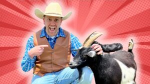 Man in a cowboy hat and brown vest crouches beside a black and white goat, pointing and smiling against a red comic-book style background.