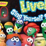 Group of VeggieTales characters posing on a stage for Live! Sing Yourself Silly 30th Anniversary promo.