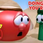 Red tomato and green bean VeggieTales characters in a desert scene, with bold 'Doing What You're Told' text in the corner and a 30th anniversary logo nearby, conveying a moment of concern or surprise.