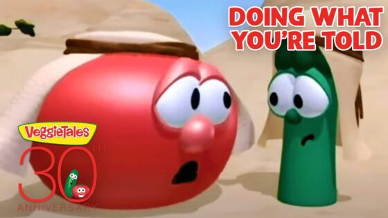Red tomato and green bean VeggieTales characters in a desert scene, with bold 'Doing What You're Told' text in the corner and a 30th anniversary logo nearby, conveying a moment of concern or surprise.