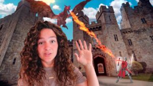 Woman with curly hair in the foreground at a castle as a red dragon breathes fire and a knight with a sword stands nearby.