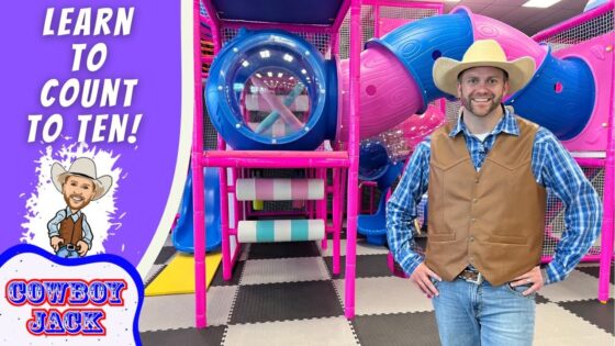 Man in a cowboy hat and vest posing in a colorful indoor playground, with a purple banner that reads 'Learn to Count to Ten!' on the left.