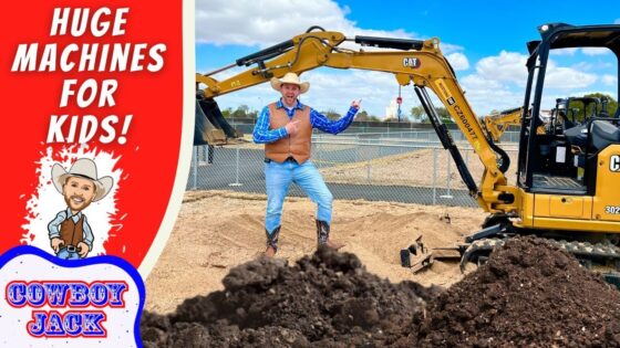 Man in cowboy outfit points at a CAT excavator on a construction site beside dirt piles and a red 'Huge Machines for Kids' banner.