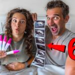 Couple in bed showing a strip of ultrasound images and six pink highlighter pens, with a large red 6 overlay in the scene.