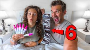 Couple in bed showing a strip of ultrasound images and six pink highlighter pens, with a large red 6 overlay in the scene.