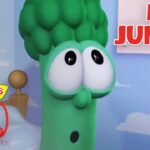 Green veggie character with large eyes in a pastel room, saying 'Meet Junior' for VeggieTales 30th Anniversary.