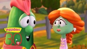 Two VeggieTales characters, a green veggie with pink hairpiece and a green-skinned girl with orange braided hair, chat outdoors next to a 30th anniversary logo.