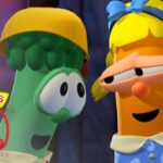 Two VeggieTales characters—a green cucumber wearing a yellow helmet and an orange carrot with a blue bow—smile at each other; VeggieTales 30th Anniversary logo in the corner.