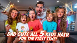 Man with a surprised face surrounded by five kids holding large hair-cutting scissors, indoors, with the bold video title text: 'DAD CUTS ALL 5 KIDS HAIR FOR THE FIRST TIME!' visible across the image