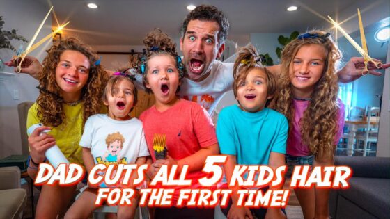 Man with a surprised face surrounded by five kids holding large hair-cutting scissors, indoors, with the bold video title text: 'DAD CUTS ALL 5 KIDS HAIR FOR THE FIRST TIME!' visible across the image