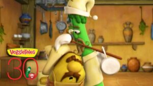 Two VeggieTales cartoon vegetables in a warm kitchen share a hug, with one wearing a chef hat and apron and the other holding a drum; a VeggieTales 30th Anniversary logo is in the lower left corner.