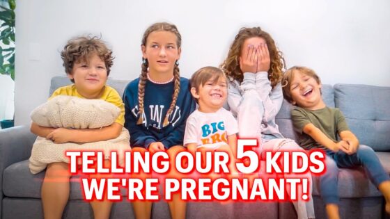 Five kids sit on a gray sofa, with a bold red text banner across the bottom that says 'Telling our 5 kids we're pregnant!'
