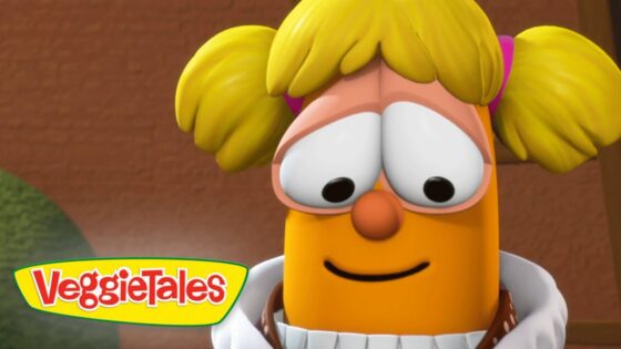 Close-up of a cheerful orange VeggieTales character with yellow pigtails and a gentle smile, VeggieTales logo in the bottom-left corner.