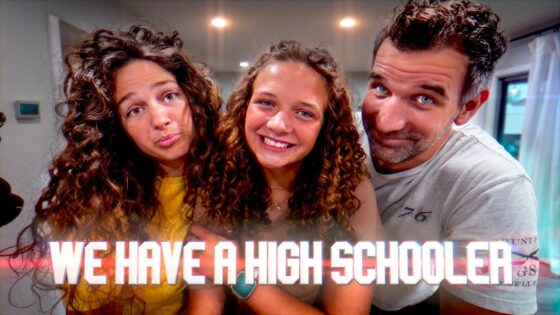 Three friends posing closely indoors, smiling at the camera, with a bold caption across the bottom reading 'WE HAVE A HIGH SCHOOLER'.