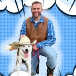 Man in a blue plaid shirt and brown vest kneels with a dog wearing a cowboy hat, against a blue comic-book backdrop with clouds and polka dots.