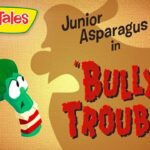 VeggieTales title card: Junior Asparagus in 'Bully Trouble' with VeggieTales logo on a textured orange background.