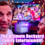 Thumbnail showing a man and a surprised child in a gaming setup with a large screen and colorful lights, promoting backyard family entertainment.