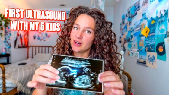 Woman with curly hair holding an ultrasound photo in a cluttered, colorful bedroom; bold video title reads 'FIRST ULTRASOUND WITH MY 5 KIDS' in red letters.