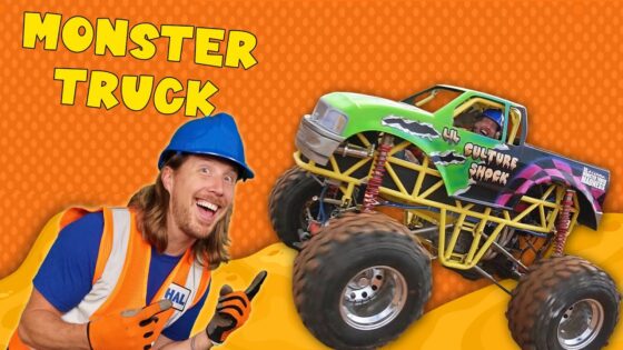 Smiling man in a blue hard hat and orange safety vest beside a bright green monster truck on an orange dotted background with 'MONSTER TRUCK' text above.