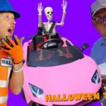 Two men react in a bright thumbnail: a construction worker and a surprised speaker stand beside a pink sports car with a skeleton figure inside, Halloween Trick text visible.
