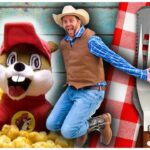 Cowboy-themed collage with a jumping man beside a chipmunk mascot, popcorn, and a cheese grater on a red checkered tablecloth with a playful vibe.
