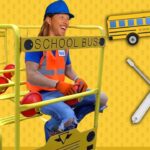 Person in a blue helmet and orange safety vest sits on a yellow school-bus riding cart, with a cartoon bus and tool icons nearby