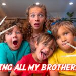 Four kids with surprised expressions pose with large scissors toward the camera, a playful home video thumbnail.