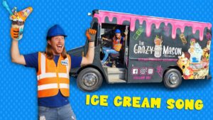 Man in orange safety vest and blue hard hat holds a huge toy ice cream cone, excited pose, against a blue dotted backdrop.