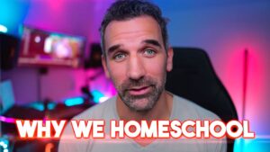 Man looks at camera in a home studio with blue/pink neon lighting; bold white text 'WHY WE HOMESCHOOL' overlays the bottom.