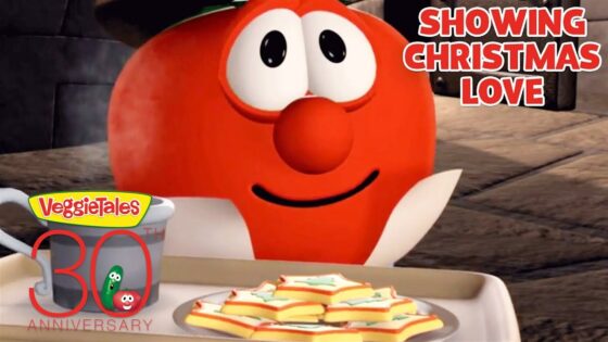 Red VeggieTales character with a mug and a plate of star-shaped cookies, celebrating VeggieTales 30th anniversary. Caption: Showing Christmas Love.