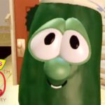 Close-up of Larry the Cucumber from VeggieTales peeking through a doorway with a warm kitchen set in the background and a VeggieTales 30th Anniversary logo in the corner.